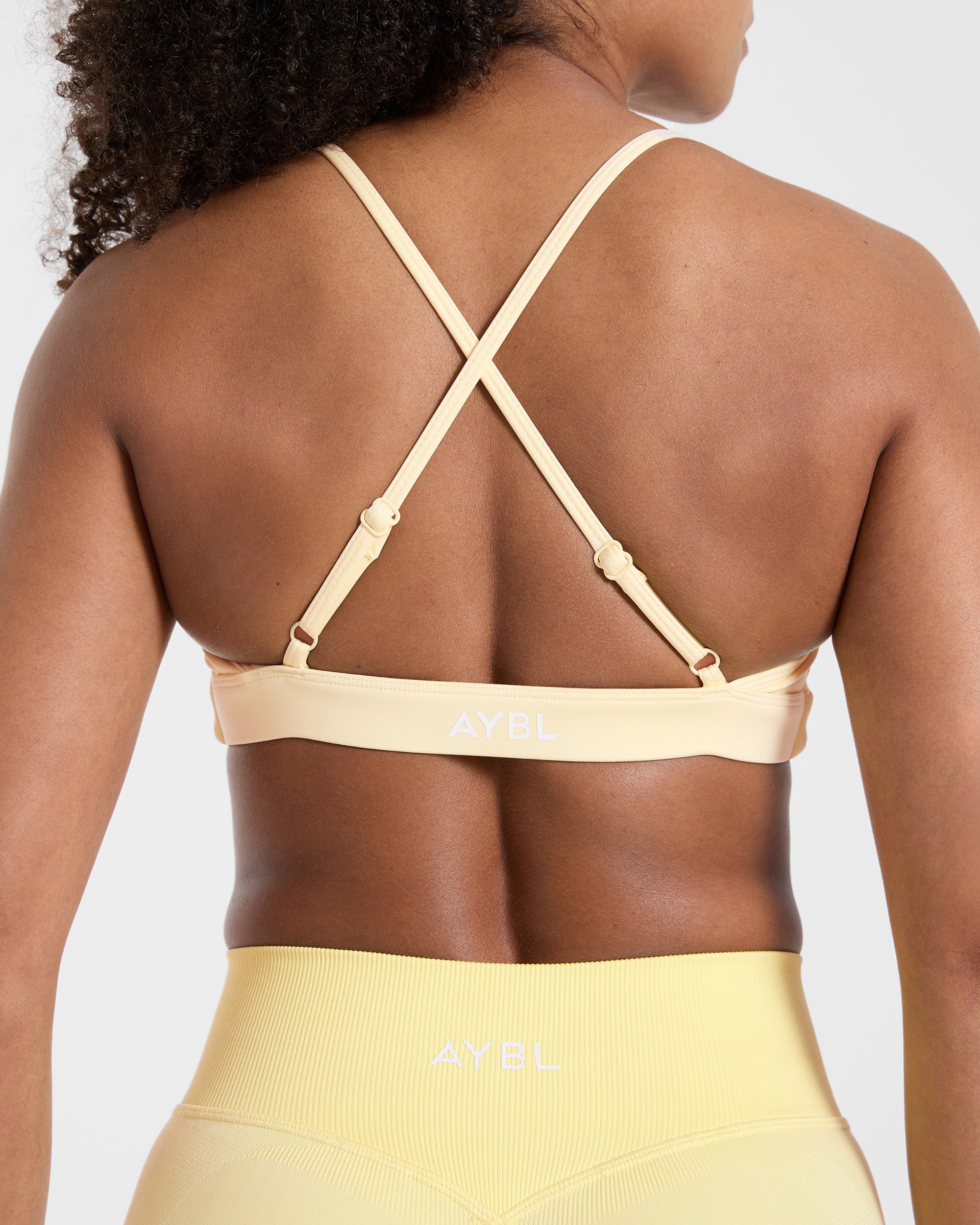 Essential Twist Crossback Sports Bra - Gelb
